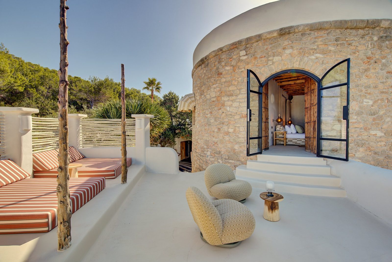 Ibiza villa terrace with stone tower and daybeds